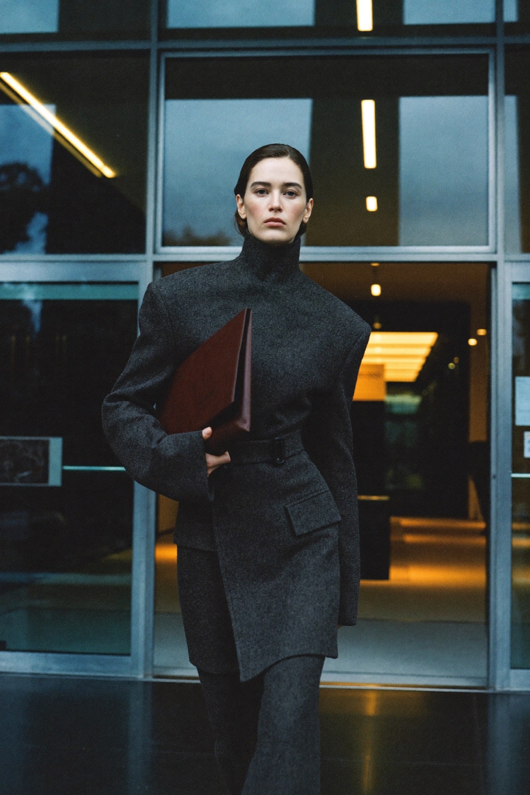 Corner Office, Day One — sharp-shouldered tailoring in a dawn lobby